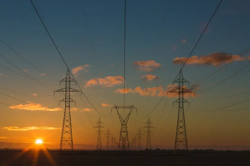 High-voltage power lines at dusk