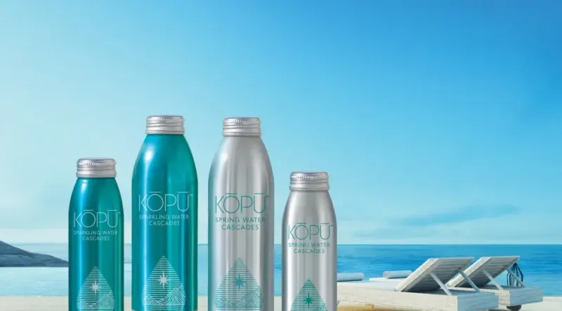 Kōpu water bottles on a beachside table