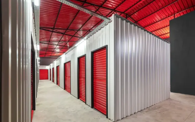 Self-storage units with red roll-up doors
