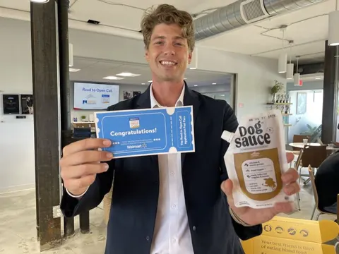 Dakota Sheets, founder of DogSauce, holding a Walmart golden ticket