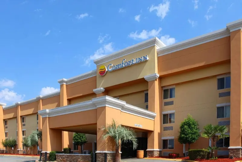 Comfort Inn hotel exterior with porte-cochère under a blue sky